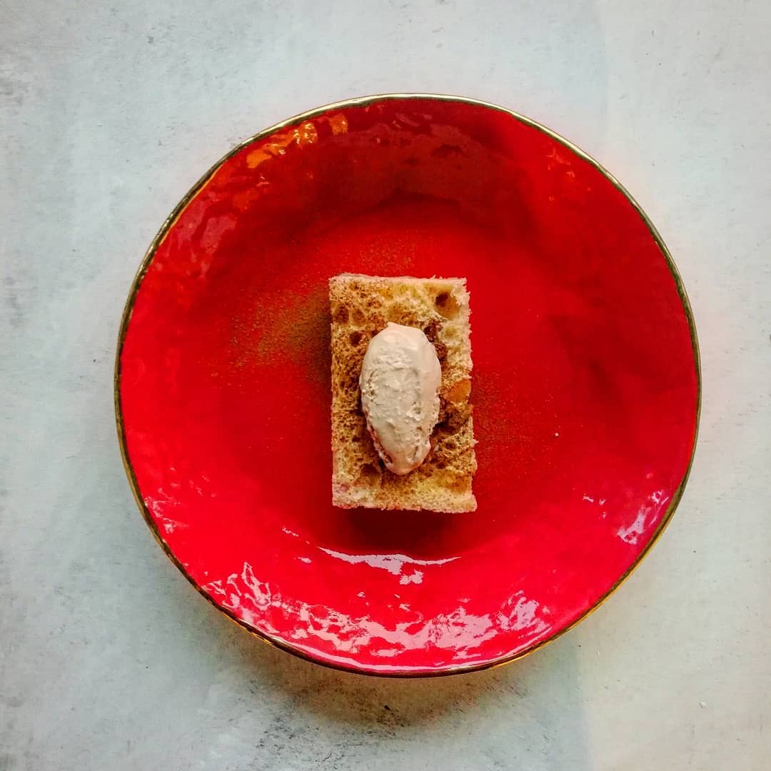 A plated dessert on a red ceramic plate